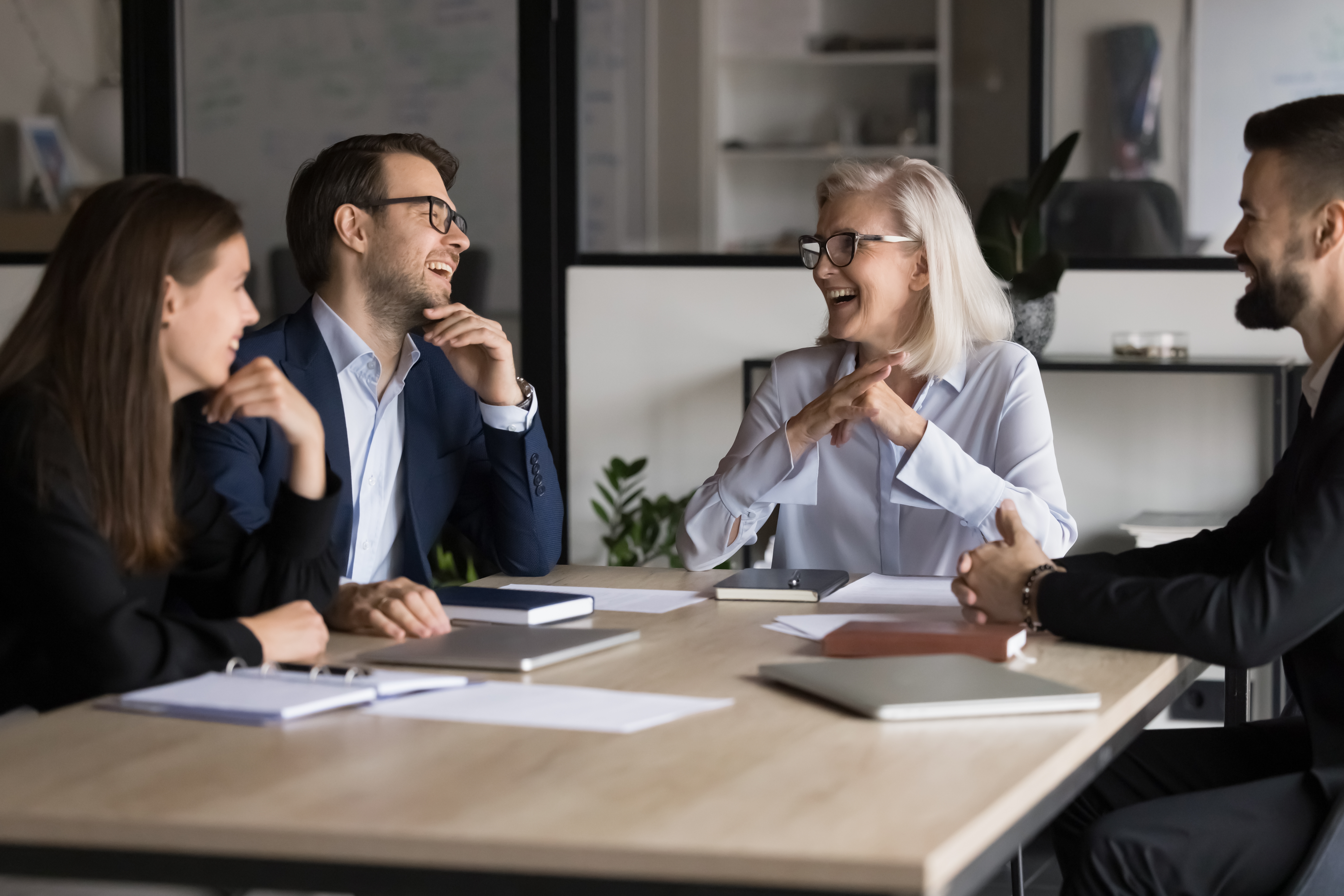 Laughing,Businesspeople,Take,Part,In,Briefing,Event,In,Boardroom.,Mature