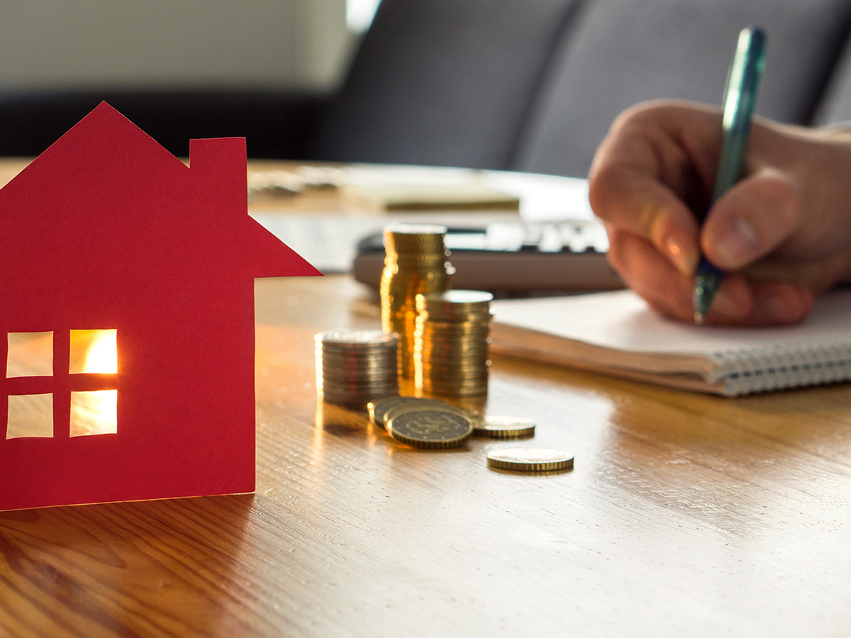 Man counting house price, home insurance cost, property value or rent on paper.