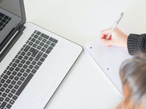 taking notes in front of computer
