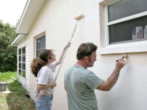 dad and daughter painting house