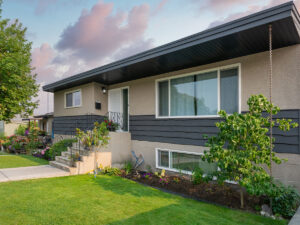 The exterior of a ranch style house. 