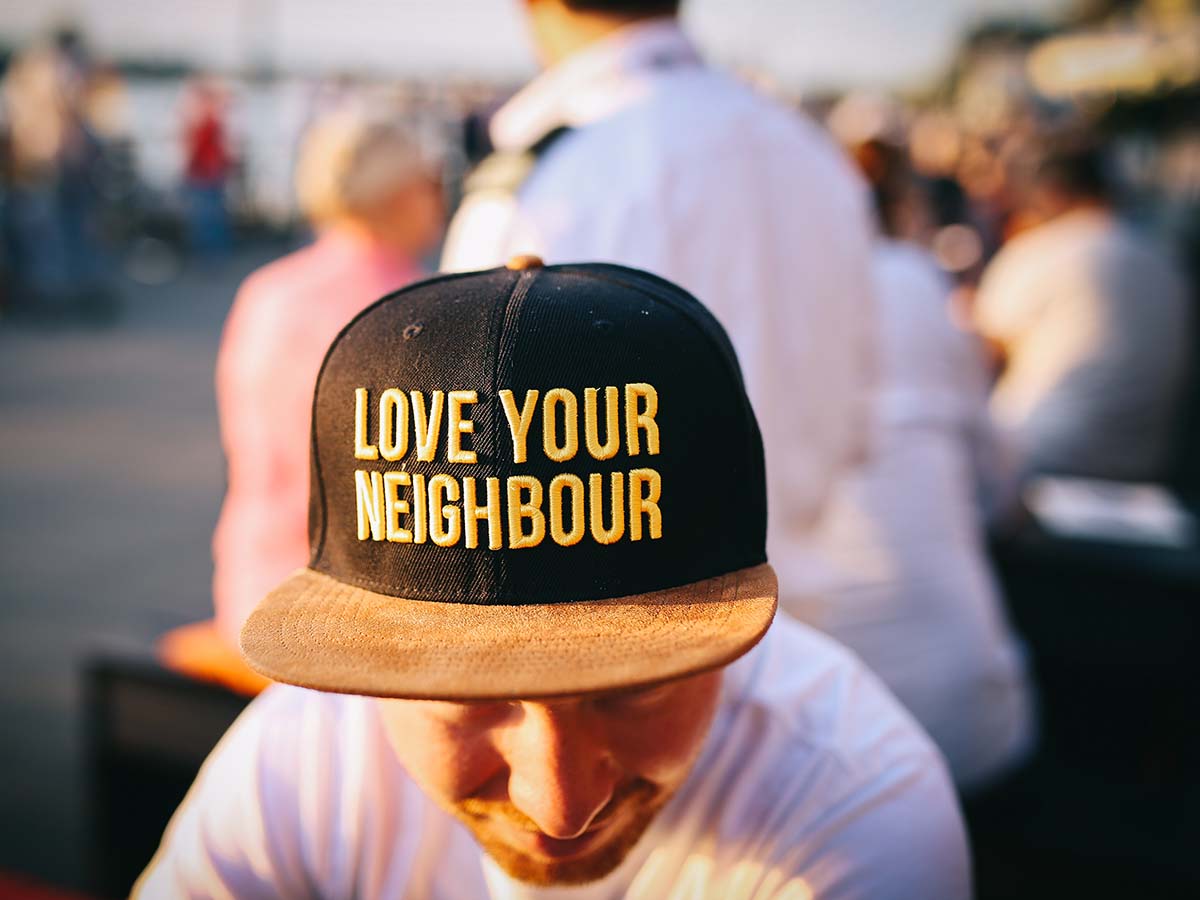 1200x900GMB-1 man with a hat that says love your neighbor