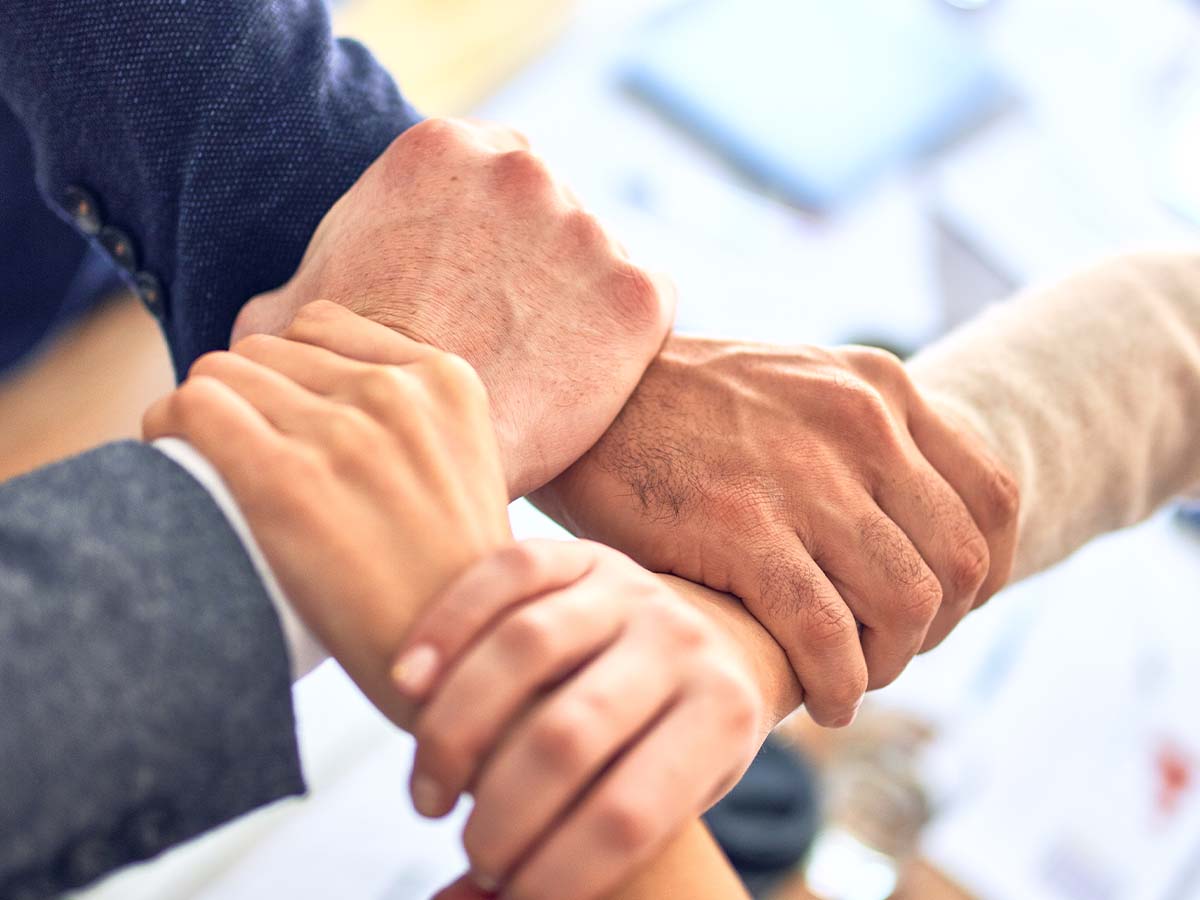 1200x900GMB-2 four people holding hands