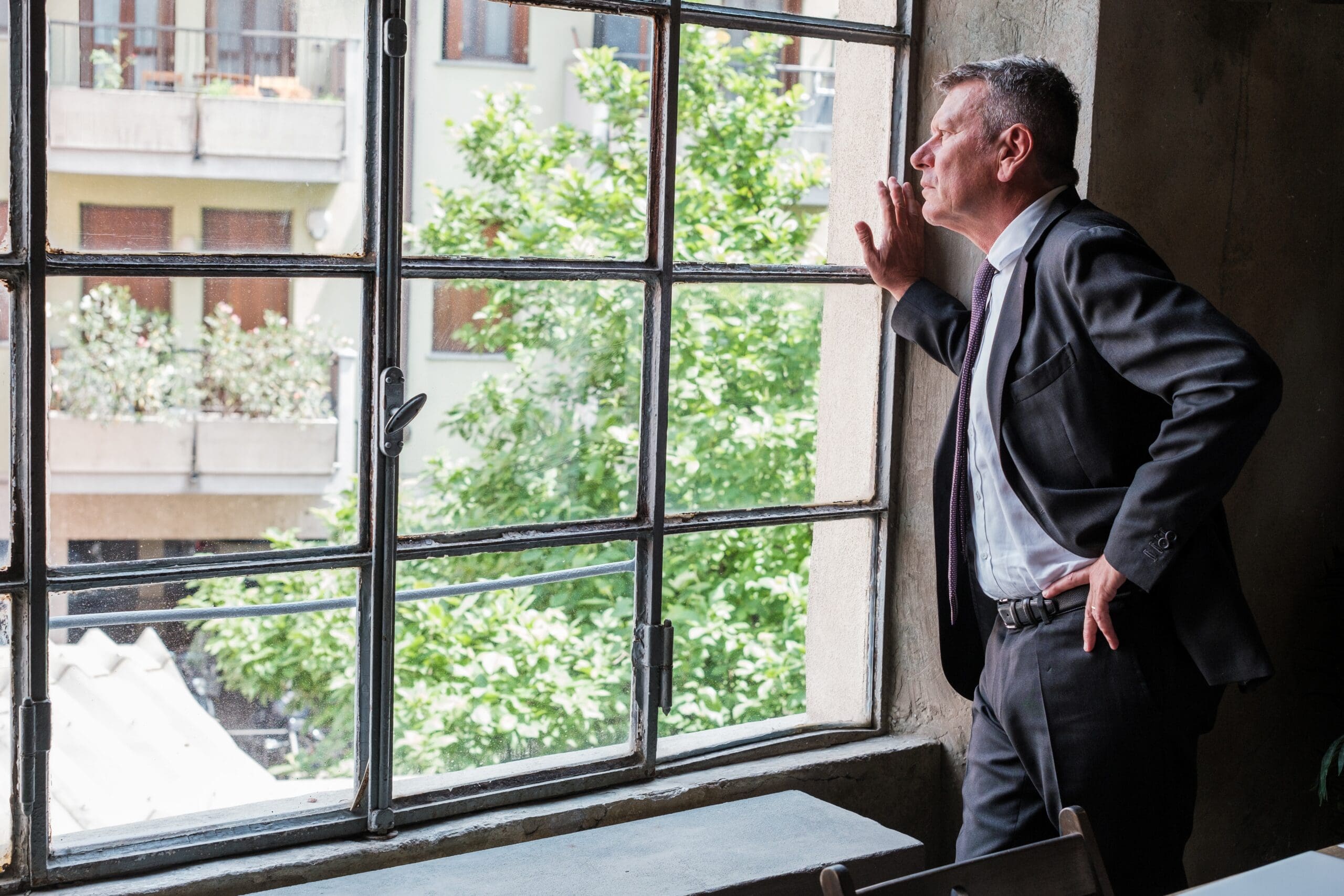 Senior,Businessman,Worried,About,The,Company,Looking,Out,The,Office