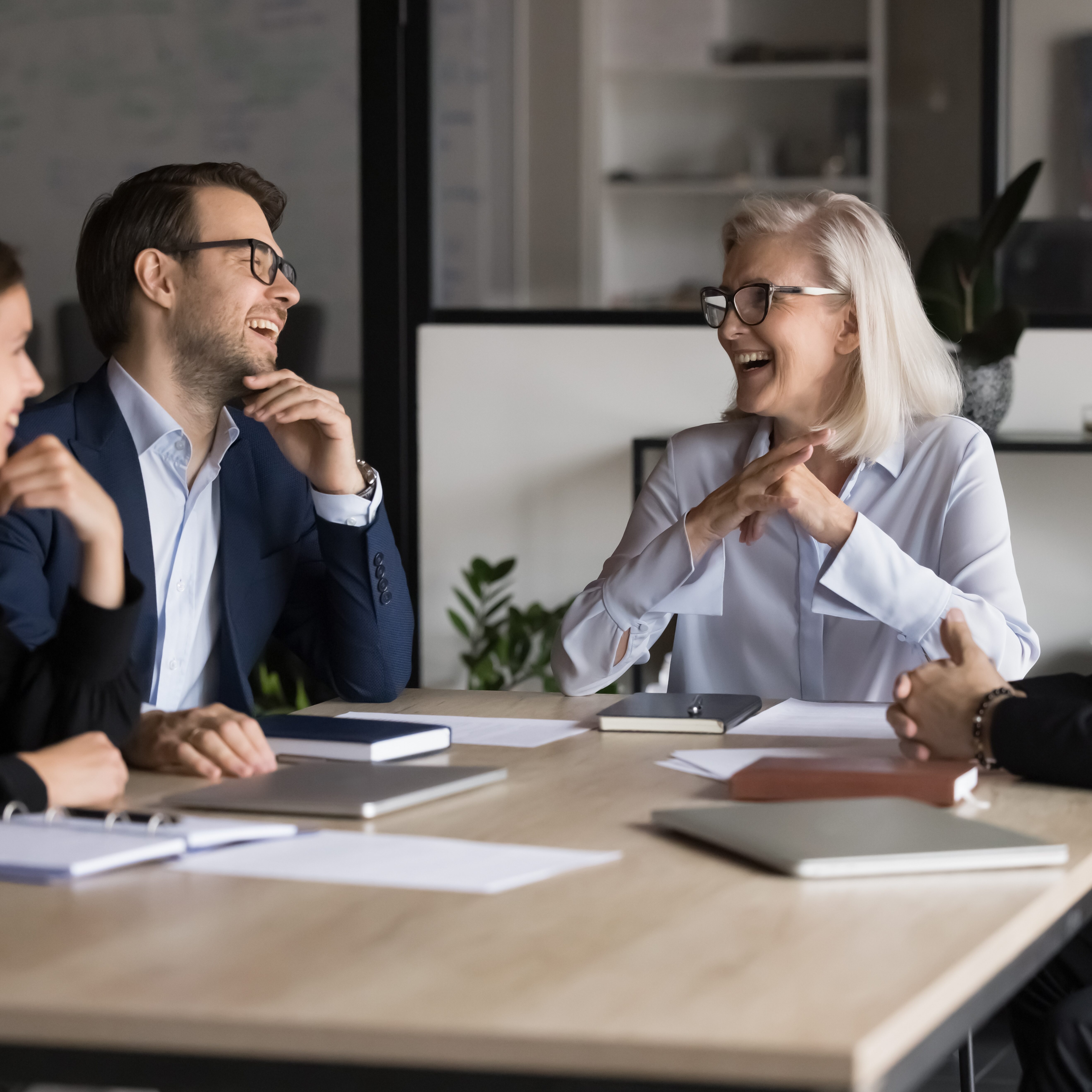Laughing,Businesspeople,Take,Part,In,Briefing,Event,In,Boardroom.,Mature